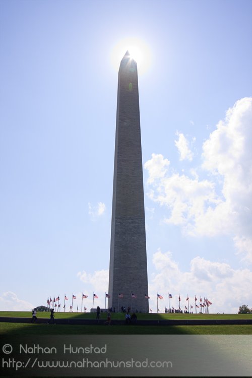 The sun peeks out from behind the Washington Monument